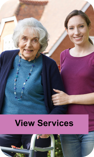 A carer and an elderly lady smiling