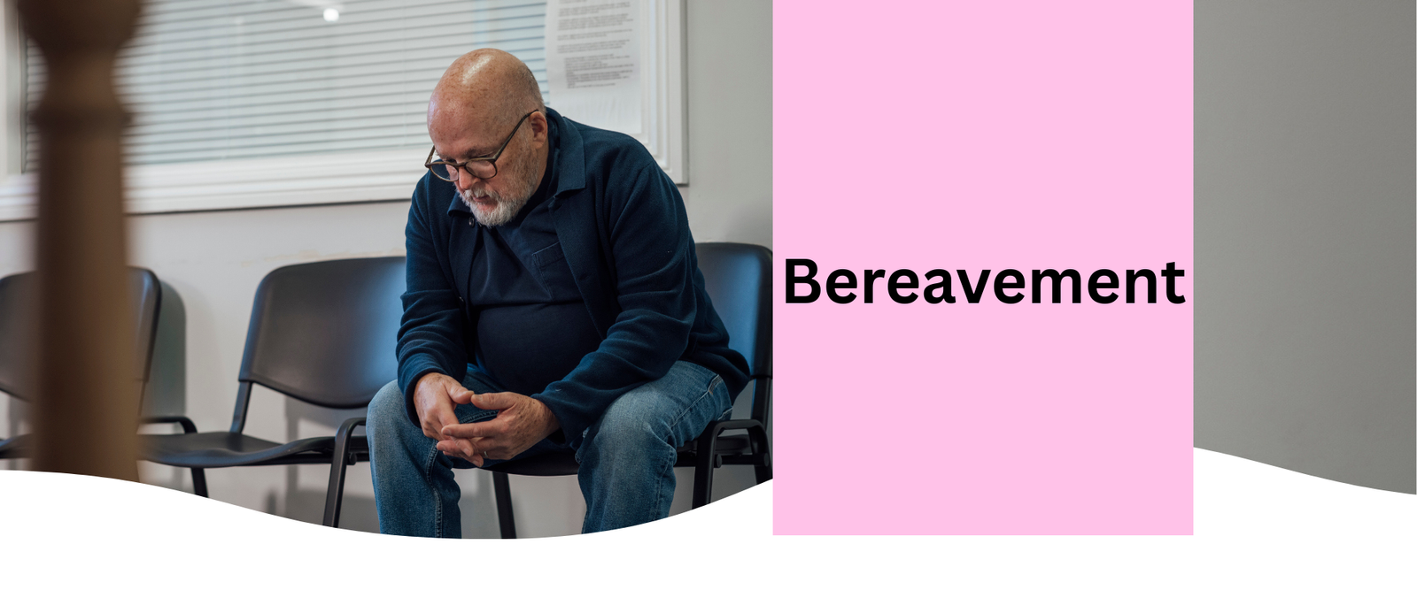 A man sitting in a corridor contemplating